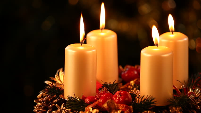 Burning candles on advent wreath and black copy space.