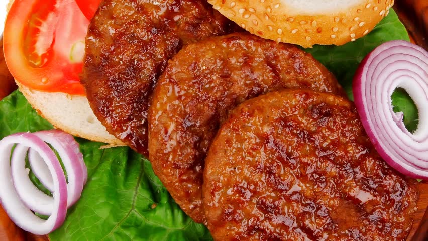 several large roast hamburger with loaf on wooden plate 1920x1080 intro motion slow hidef hd