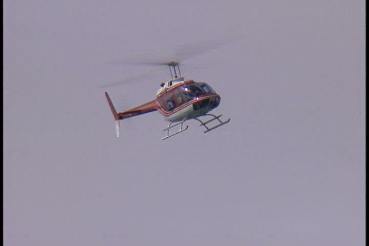 WAIKIKI BEACH, HONOLULU, HAWAII - JANUARY 30, 1997: scenic b-roll at Waikiki Beach, Hawaii: helicopter flies overhead in overcast sky.