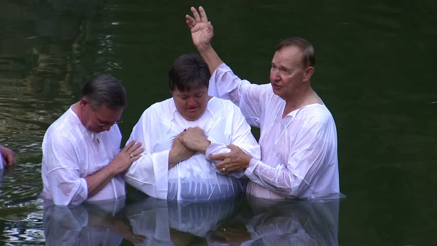 Jordan River, Israel - APRIL 22: Christian pilgrims to the holy land immerse themselves in the waters of Biblical Jordan River during a mass baptism ceremony April 22, 2009 in Jordan River, Israel.