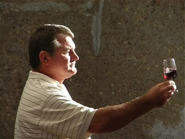Winemaker tasting wine closeup