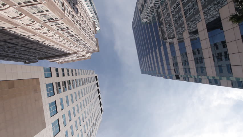 Low angle view circle tracking motion shot of skyscrapers, office building, business tower in Bangkok city, capital of Thailand, realistic cinema, film, movie taken from car rig mount for background
