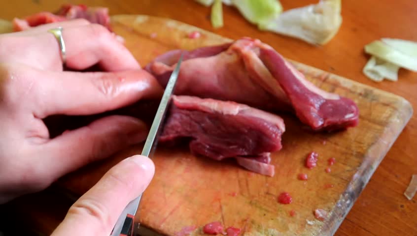 Cutting the meat on a wooden board