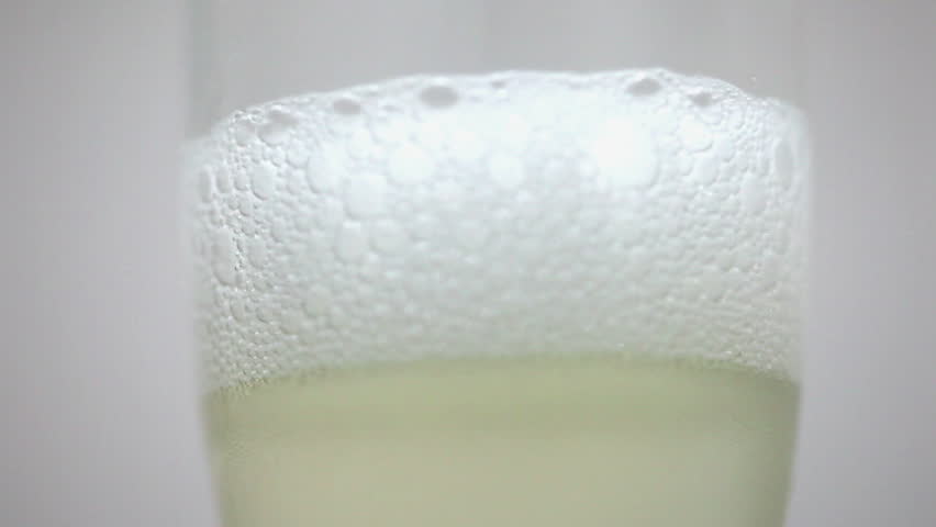 Closeup sparkling wine with bubbles in a glass