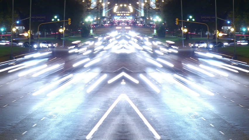 Traffic in the city. Avenue Time-Lapse, symmetric / mirrored, Night. Moon going down. Heavy traffic / jam / flowing with blurred motion.