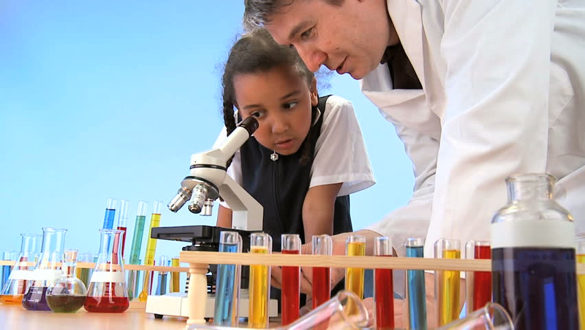 Teacher & pupil in elementary school science laboratory
