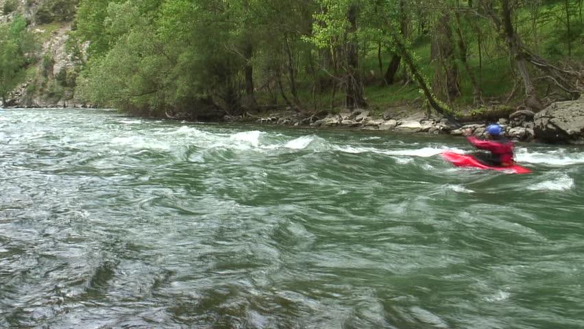 1080i, not rendered: Kayaks passing by on a whitewater river. Tripod.