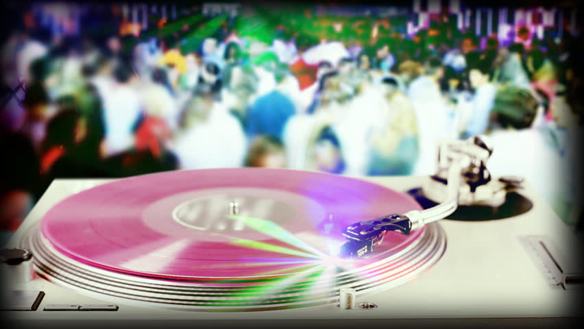dj record turntable with blurred dance crowd in background