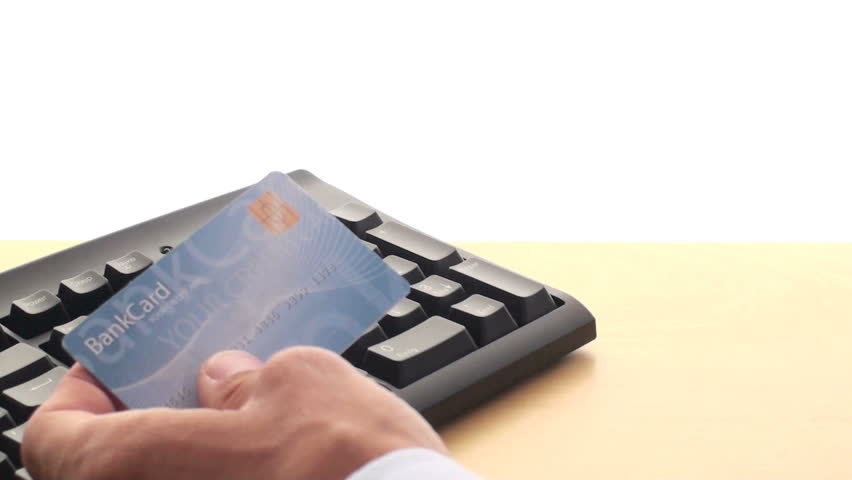 man pays online with bank card 
