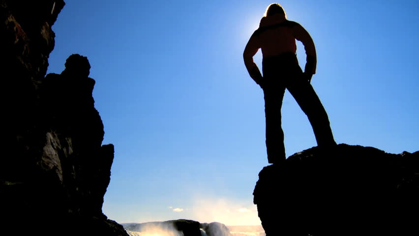 Lone young female reaches a stunning waterfall on her hiking adventure 60 FPS 