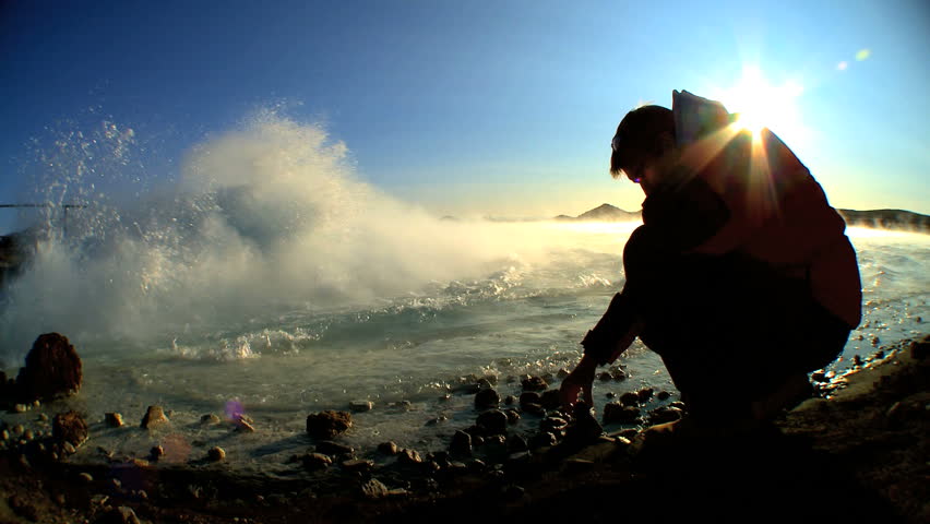 Piece of glacial ice being examined by geothermal scientist for signs of global warming