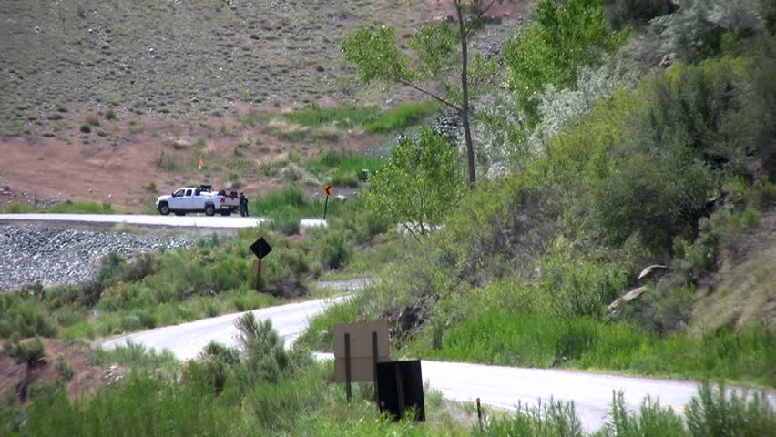 HD clip of a tanker truck coming loudly off the face of Navajo Dam in northern New Mexico