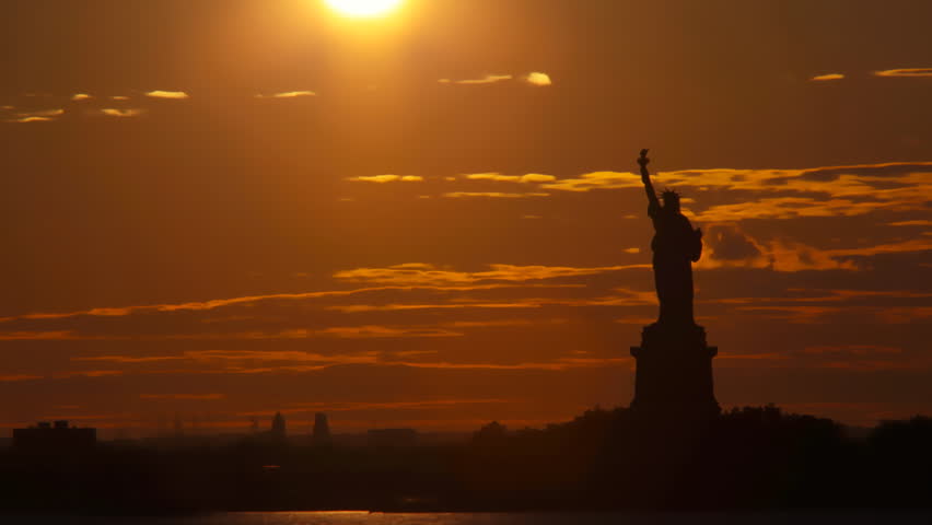 Sunset behind statue of liberty