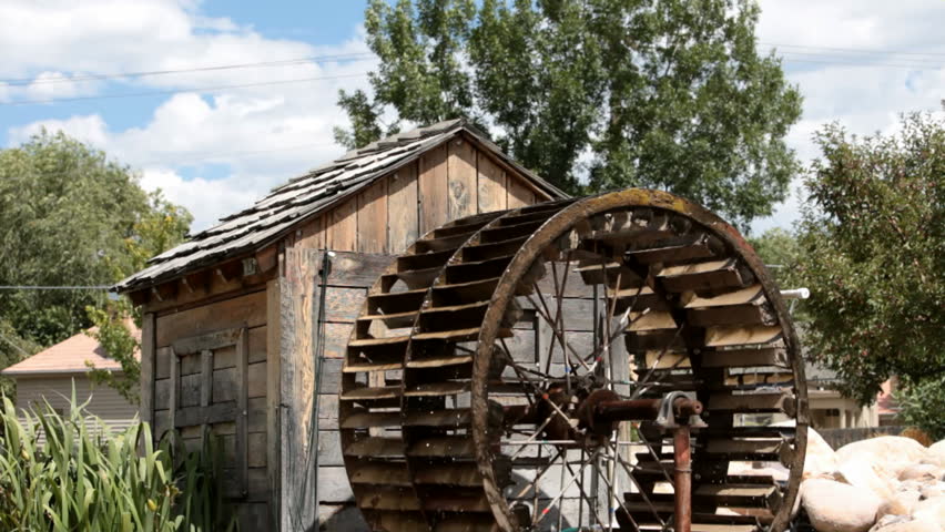 Small old antique water wheel. Turning from power of a small creek in central Utah. Used for a mill. 