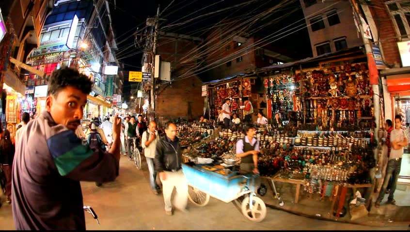 KATMANDU - APRIL 9: Bicycle rickshaw drives night tour through Thamel streets April 7, 2009 in Kathmandu, Nepal. According to NATTA information KMC plans to turn Thamel into a "Vehicle-free" Zone.