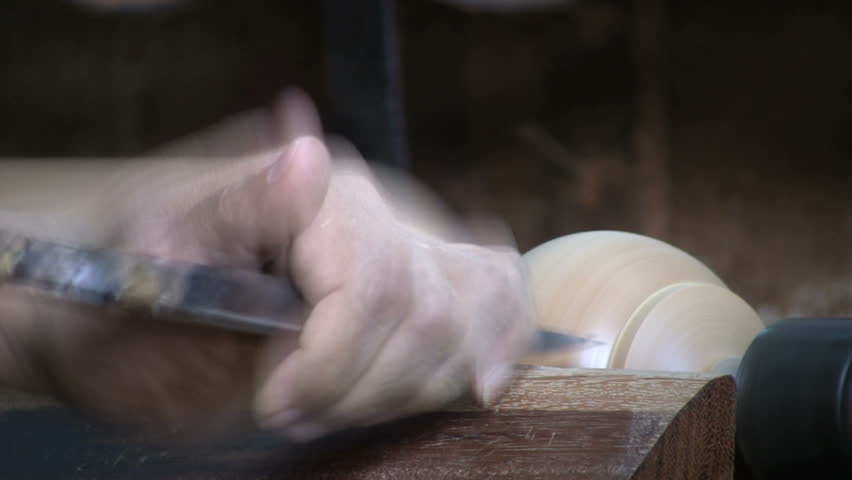 A close up shot of a man working on an old style lathe in Bangkok, Thailand.