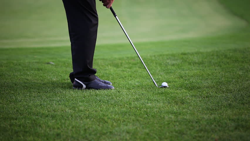 Golf player teeing off on beautiful golf course