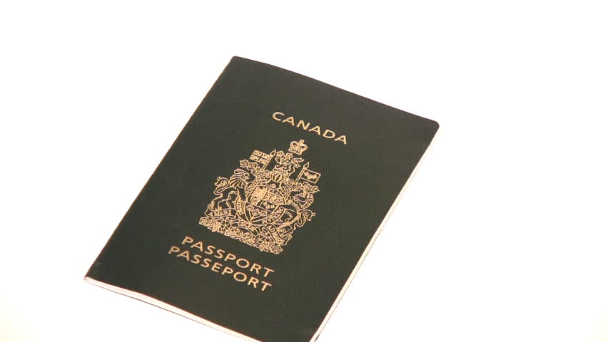 Zooming in on a closed Canadian Passport, isolated on white.
