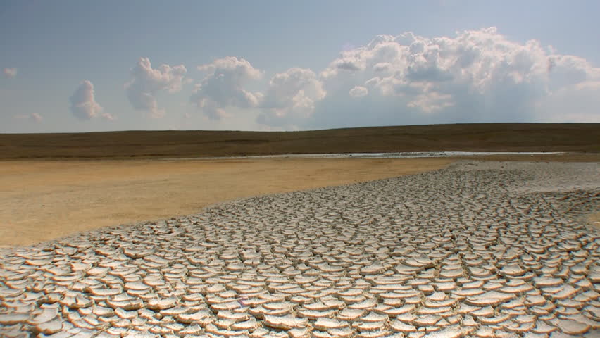 Clouds timelapse, dry cracked land with muddy volcano, HD