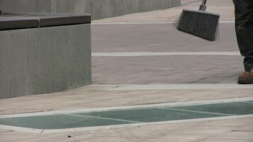 A sidewalk cleaner cleans up a plaza area after construction crews have finished laying new sidewalk bricks, planters and benches in the busy downtown area.