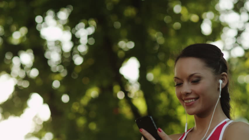 Pretty Girl using Phone Before Running.Shot on RED Digital Cinema Camera in 4K(ultra-high definition (UHD)),so you can easily crop, rotate and zoom, without losing quality.