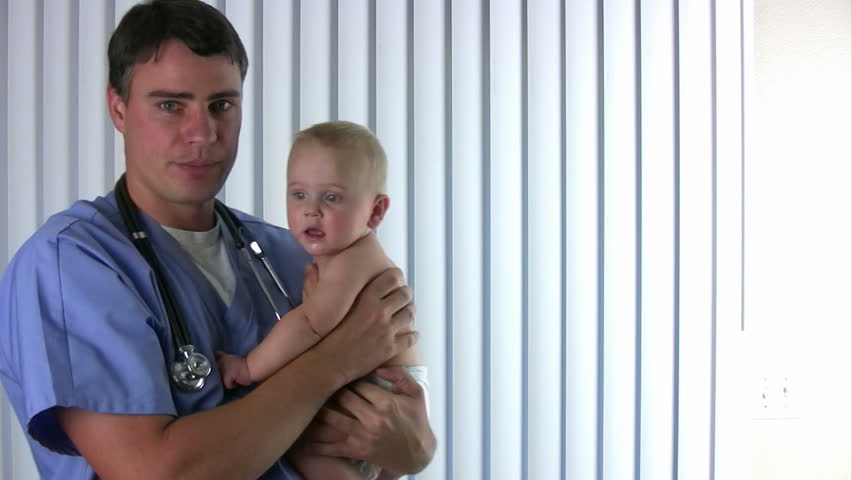doctor holds a happy healthy baby