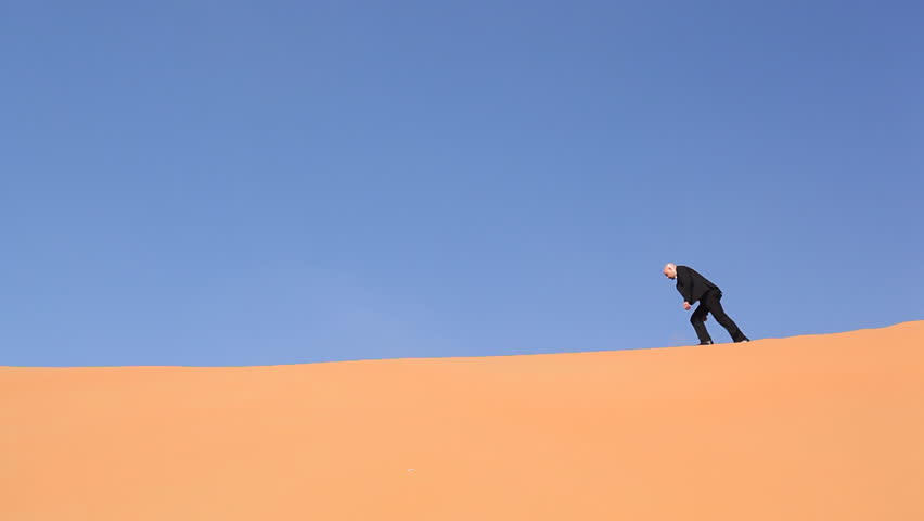 hopeless and weak businessman alone in desert