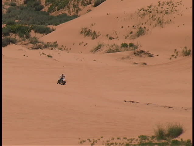 ATVs speed and jump across the red sands of the Coral Pink Sands State Park in southern Utah.