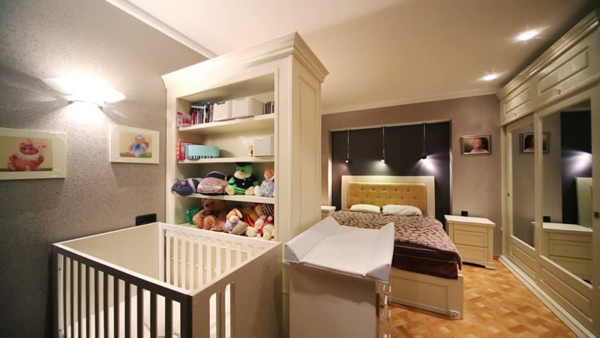 Studio Apartment With Baby white baby cot, closet with toys and bedroom in cozy and little Studio Apartment With Baby white baby cot, closet with toys and bedroom in cozy and little