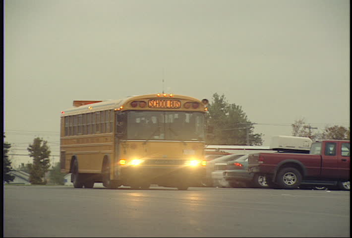 2 school buses pull into parking lot