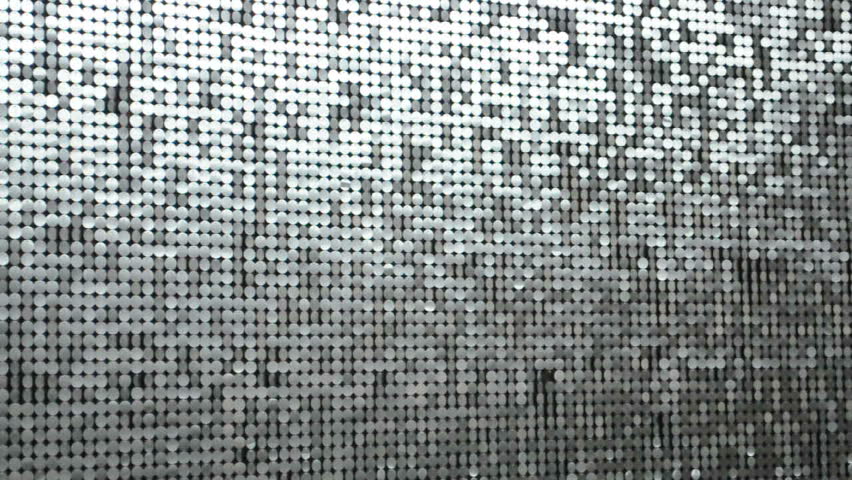 a wall of silver sequins, medium shot with increasing sparkles