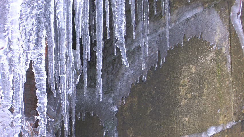 HD Icicles hanging from pipe on building background, closeup, Canon XH A1, FullHD video, 1080p, 25fps, progressive scan 