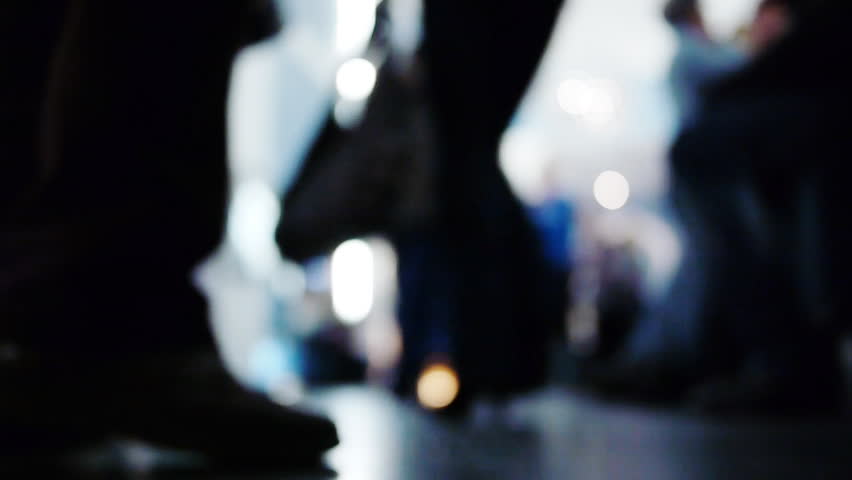 Defocused anonymous Crowd in the hall with Sound. Slow motion.