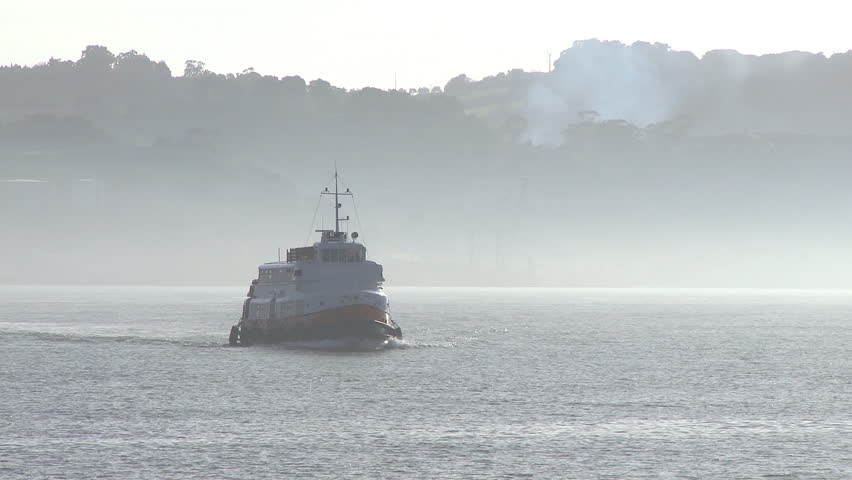 Ferry boat across the river in fog