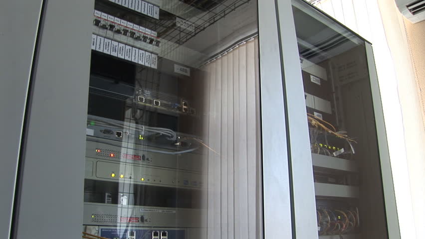 media converters in racks connected with fiber optic and ethernet cables panorama