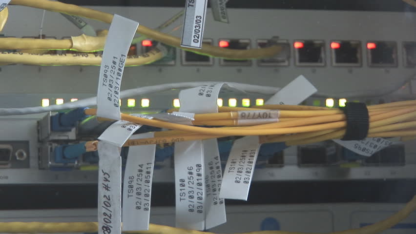 media converters connected with fiber optic and ethernet cables go in and out of focus then the reflection of man appears