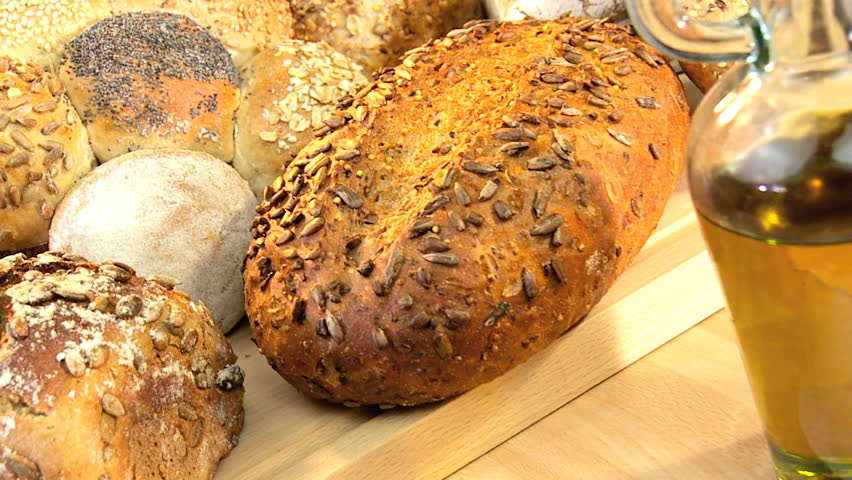 Selection of fresh organic breads baked with healthy nuts & seeds and served with olive oil