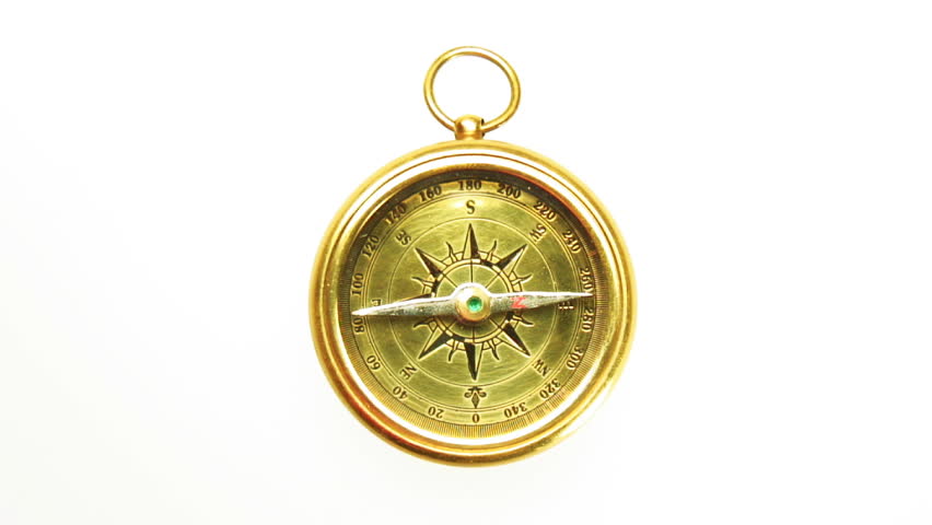 Old brass compass compass with needle swinging isolated on white