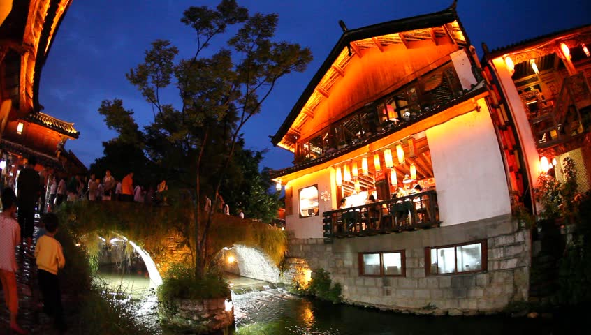 LIJIANG, CHINA - August 20: In the peak of the season, Chinese and world travelers enjoy  old town Lijiang including old architecture, restaurants and the local river, August 20, 2009 in Yunnan.