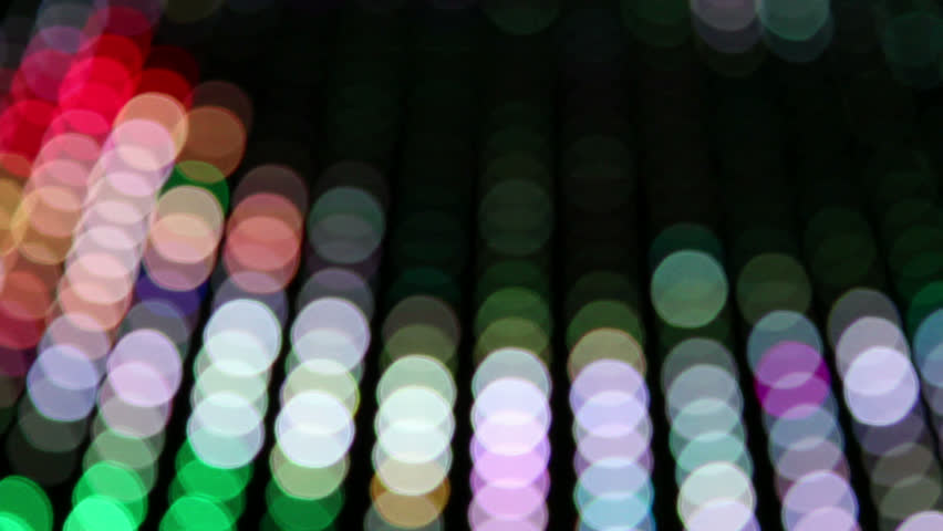 Blurred neon lights, predominantly orange, moving across frame