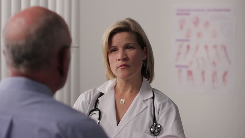 Female Doctor with patient in exam room