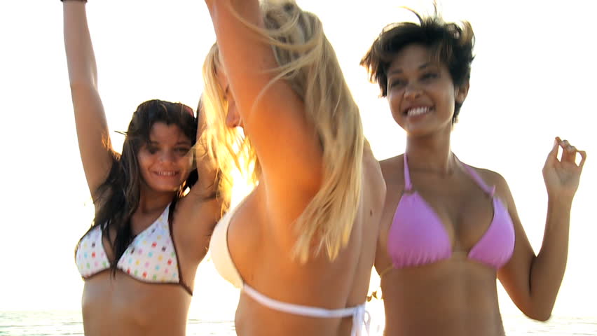 Head & shoulders of three beautiful carefree girls in bikini's dancing on the beach 60FPS
