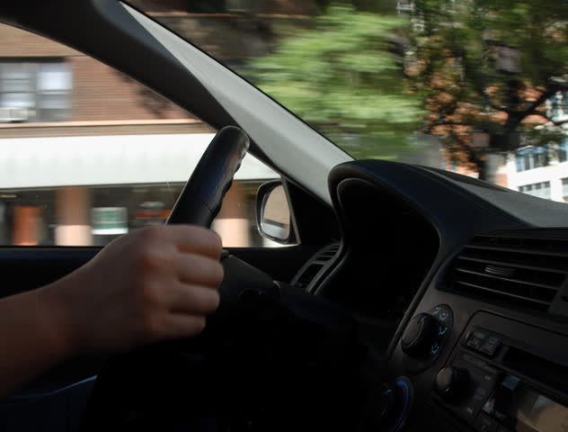 Steering car through city traffic time lapse