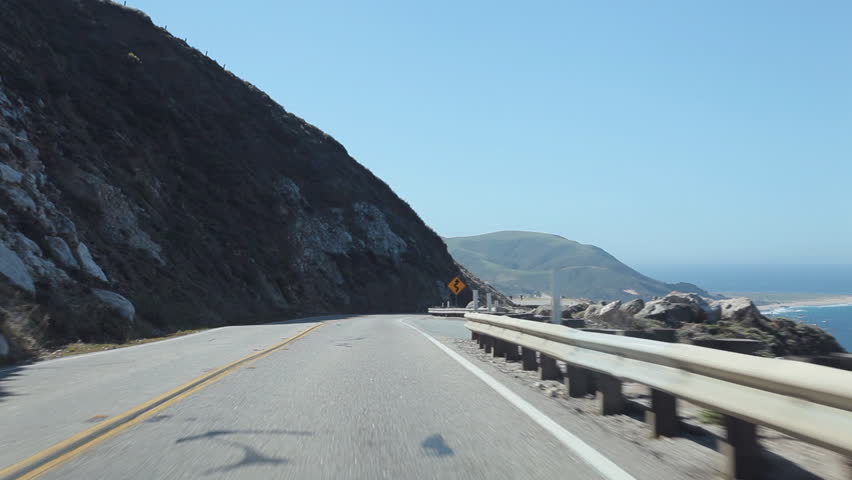 A view of driving on Pacific Coast Highway (aka Highway 1) on the Central California coastline in the Point Sur area of Big Sur. 