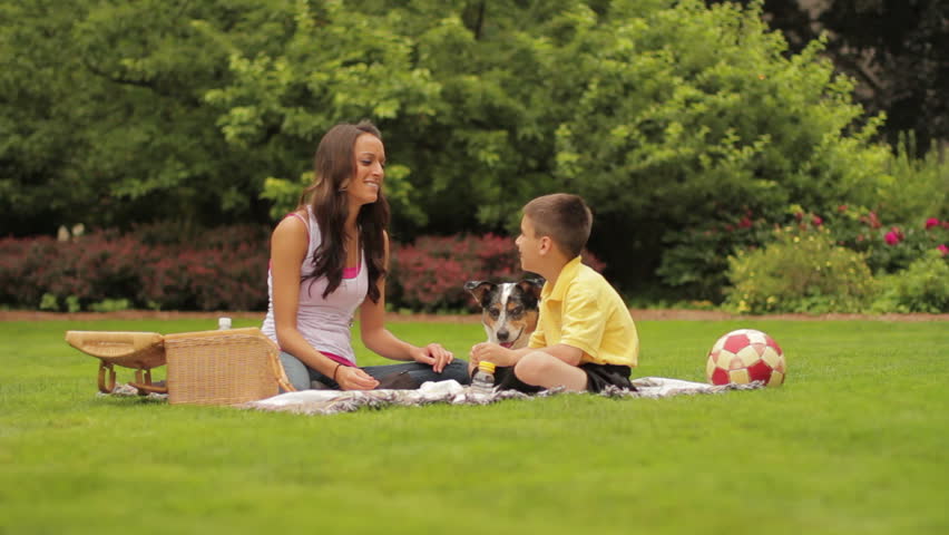 Mother and son having a picnic with their dog
