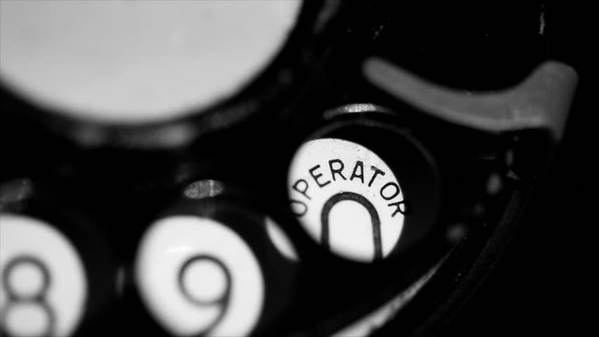 A macro shot of the rotary pulse dialing of a vintage telephone.