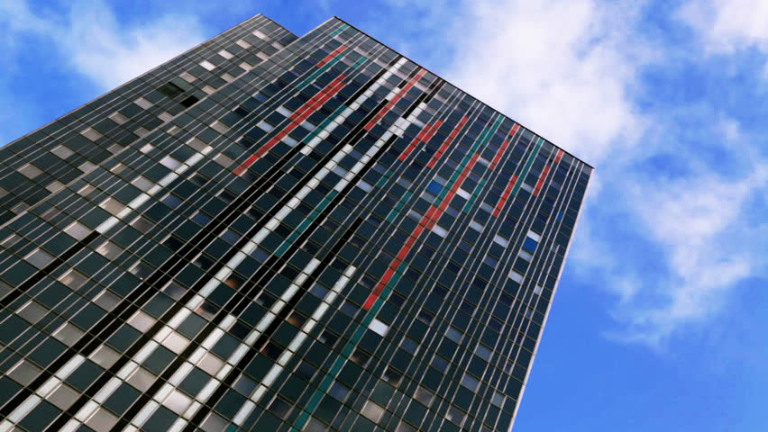 Skyscraper with fast moving clouds.Time-lapse