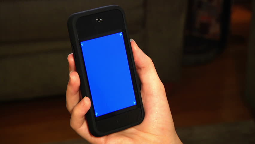 Holding a mobile smartphone.  Blue screen for your custom video content with corner has marks for advanced tracking.  Shot 4:2:2 for clean keying.  Luma matte included.