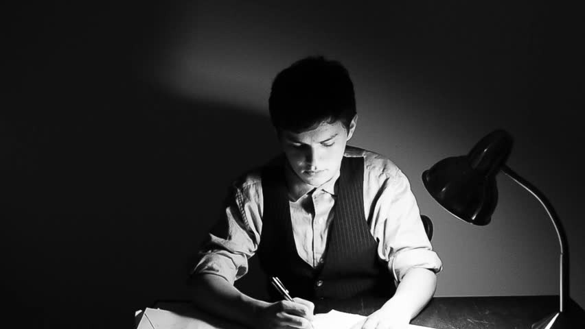 A young man frantically trying to do an overwhelming amount of paper work. Black and white HD 720p footage.