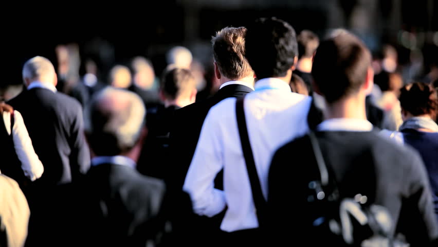 Head & shoulders of morning commuters walking to work in a busy city environment